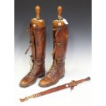A pair of brown leather riding boots, fitted with wooden lasts by Peal & Co, London, together with a