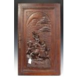 A late 19th/early 20th century French oak door, carved in high relief with two figures on horseback,