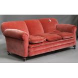 A George V three seat settee, upholstered in pink velour, on bun feet, height 81cm, width 200cm,