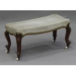 A Victorian walnut footstool, the overstuffed top upholstered in green velour, on cabriole legs