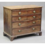 A late George III mahogany chest of four long drawers, the crossbanded top above a brushing slide,