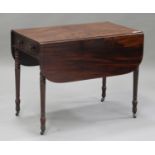 A Victorian figured mahogany Pembroke table, fitted with a frieze drawer, on turned legs and