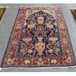 A Central Persian prayer rug, late 20th century, the blue mihrab with overall flower-filled urns and