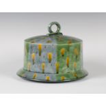 A Kevin de Choisy studio pottery cheese dome and stand, glazed with alternating green and pale