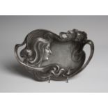 An Art Nouveau WMF cast metal tray, decorated in relief and pierced with a maiden's head,