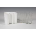 An Iittala clear glass vase, designed by Alvar Aalto, and a matching white glass vase, both