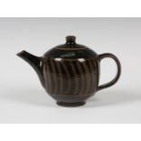 A David Leach studio pottery stoneware teapot and cover, covered in a tenmoku glaze with a wide band