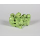 A rare Bernard Moore lime green glazed monkey group, early 20th century, modelled as five seated