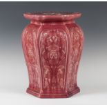A pink glazed Minton type pottery jardinière stand, circa 1900, the hexagonal tapered body relief