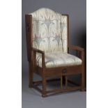 An Edwardian Arts and Crafts oak framed armchair, designed by G.M. Ellwood for J.S. Henry,