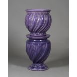 A Mintons majolica purple glazed jardinière and stand, circa 1912, the bulbous shaped jardinière
