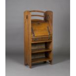 An Edwardian Arts & Crafts oak student's bureau, in the manner of Wylie & Lochhead, the raised