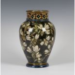A Doulton Lambeth Faience vase, dated 1877, of high shouldered form, painted with stems of white