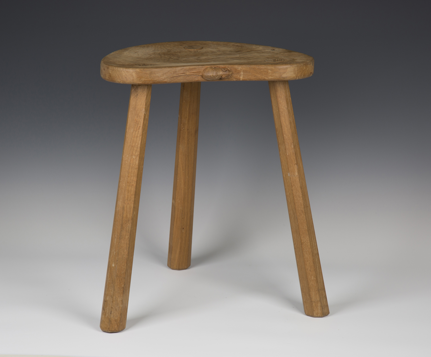 A Robert 'Mouseman' Thompson oak stool, the kidney shaped seat panel with typical carved mouse