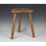 A Robert 'Mouseman' Thompson oak stool, the kidney shaped seat panel with typical carved mouse