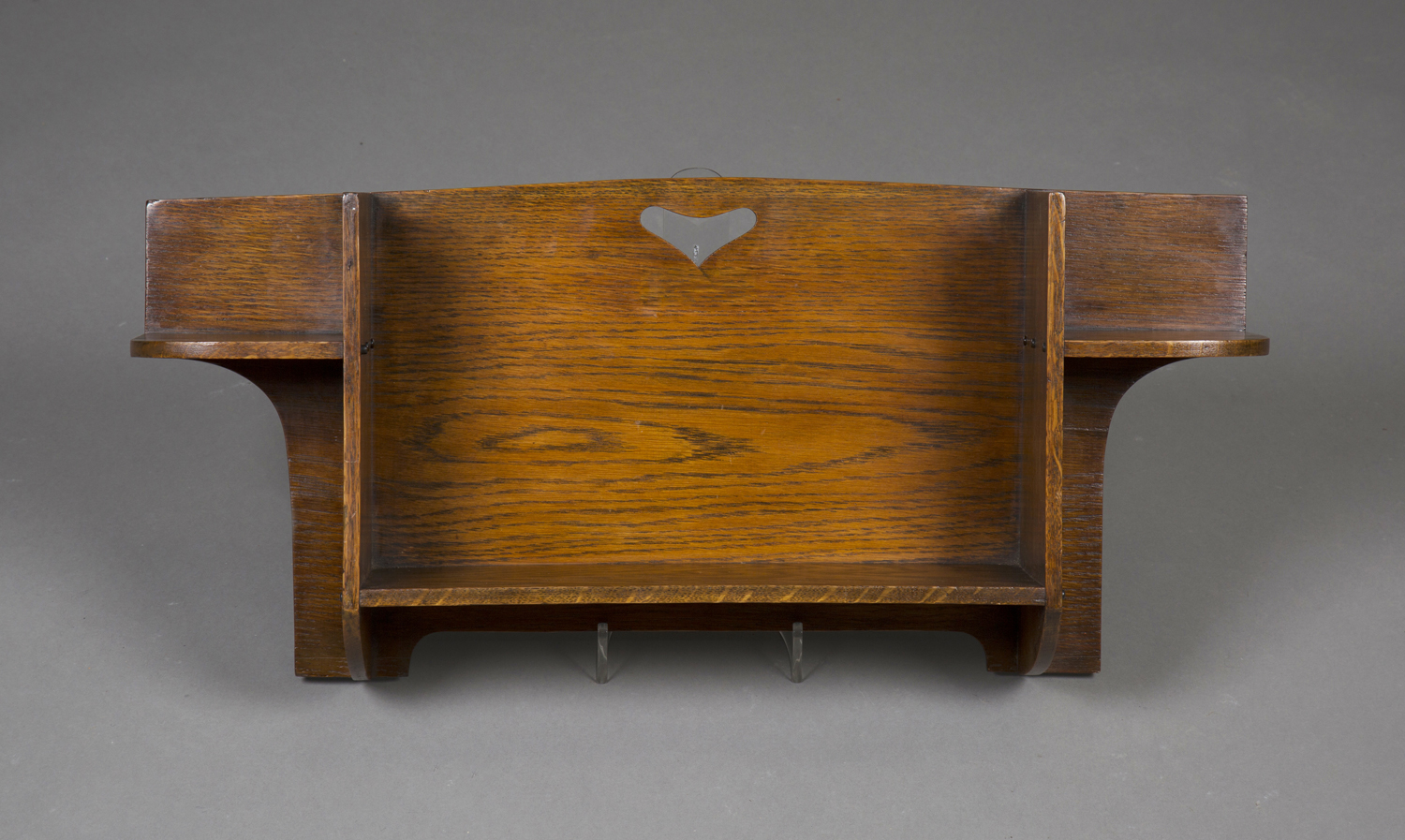 An Edwardian Arts and Crafts oak 'Hillingdon' wall bracket by Liberty & Co, the open shelf back with