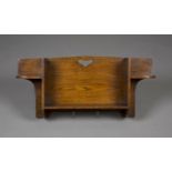 An Edwardian Arts and Crafts oak 'Hillingdon' wall bracket by Liberty & Co, the open shelf back with