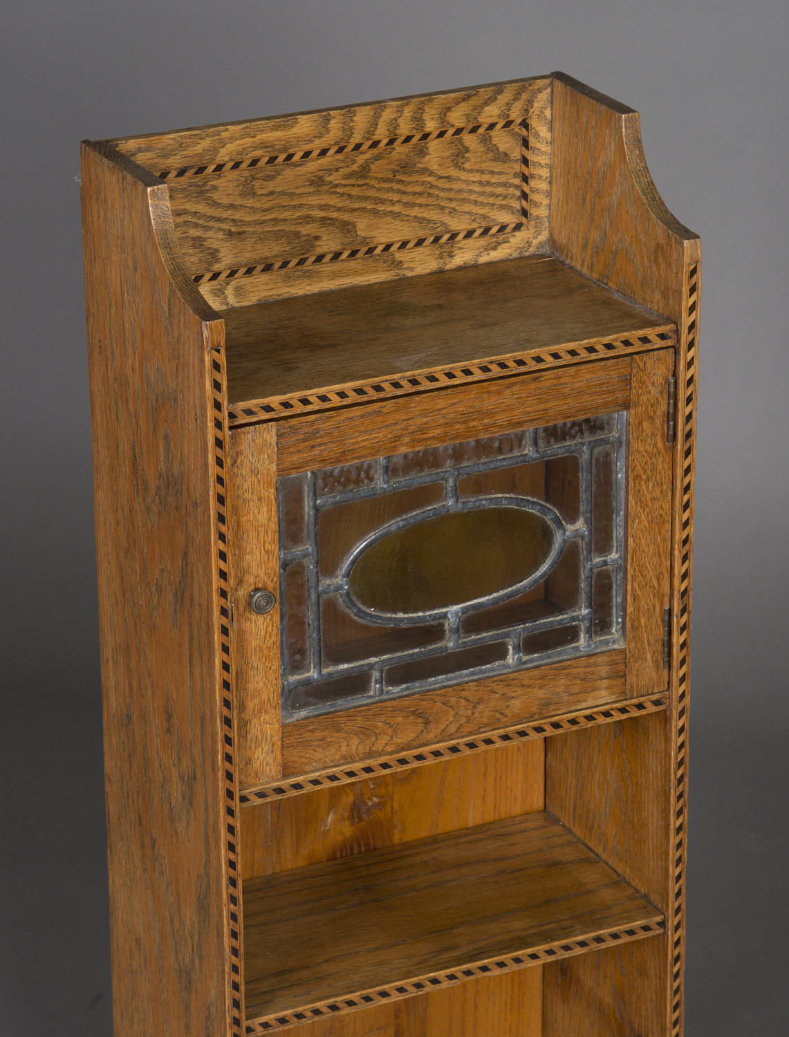 An early 20th century Arts and Crafts oak narrow bookcase, in the manner of Liberty & Co, fitted - Image 2 of 3