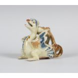 A C.H. Brannam Barum pottery chamberstick, dated 1891, modelled as a crouching dragon, his curled