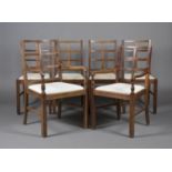 A harlequin set of six Heals style oak dining chairs, comprising a set of four standard chairs and