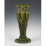 A Leeds Art Pottery green glazed jardinière stand, circa 1900, the central stem moulded with