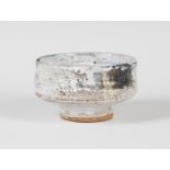 A Robin Welch studio pottery stoneware footed bowl, the textured body covered haphazardly in a white