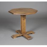 An early 20th century Heals style oak octagonal occasional table, the moulded top above a reeded