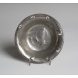 A Liberty & Co 'Tudric' pewter pierced circular dish, model number '0546', decorated with overall