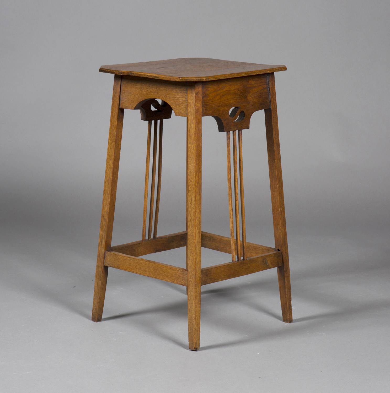 An Edwardian Arts and Crafts oak canted square occasional table, in the manner of Wylie & Lochhead