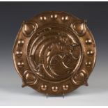 A late 19th/early 20th century Arts and Crafts copper charger, attributed to Norman and Ernest