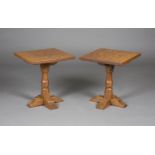A pair of Arts and Crafts Yorkshire School oak occasional tables, in the manner of Robert