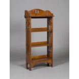 An Edwardian Arts and Crafts oak four-tier open bookcase, in the manner of Liberty & Co, the