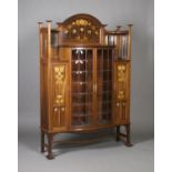 An Edwardian Arts and Crafts mahogany display cabinet by Shapland & Petter of Barnstaple, the raised