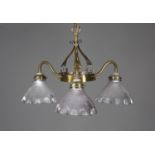 An Edwardian Arts and Crafts brass three-branch ceiling light, in the manner of W.A.S. Benson, the