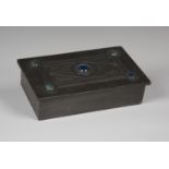 An Arts and Crafts pewter box of rectangular form, the hinged lid inset with five blue/green