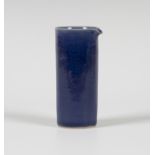 A Rupert Spira studio pottery pouring vessel, the cylindrical body covered in a blue glaze, seal