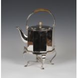 A large Edwardian Arts and Crafts style plated electric kettle, the wicker-covered overhead handle