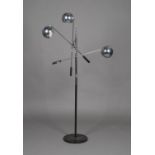A mid-20th century chromium plated adjustable floor-standing lamp, the three spherical shades on