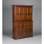 An Edwardian Arts and Crafts mahogany side cabinet of small proportions, the moulded top above