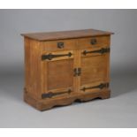 An early 20th century Arts and Crafts oak side cabinet, possibly by the Guild of Handicraft,