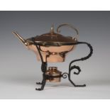 A late Victorian copper kettle on a wrought iron heater stand, in the manner of W.A.S. Benson, the