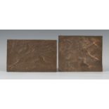 Two early 20th century Arts and Crafts hammered copper rectangular panels, each finely worked with a