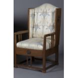 An Edwardian Arts and Crafts oak framed armchair, designed by G.M. Ellwood for J.S. Henry,