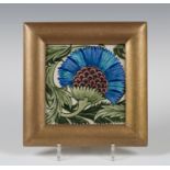 A William de Morgan Poole Architectural Pottery BBB tile, circa 1880, the blue and maroon flower