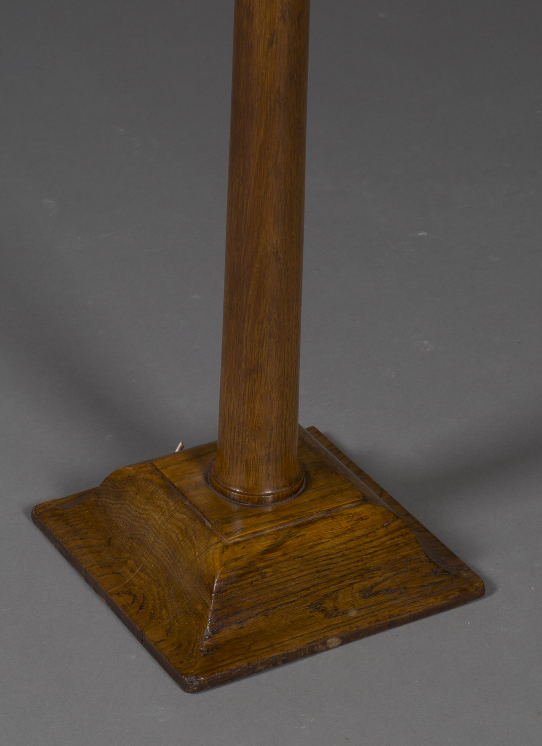 An early 20th century Arts and Crafts oak lamp standard, the tapering stem raised on a shaped square - Image 2 of 2