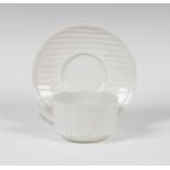 A Rupert Spira studio pottery breakfast cup and saucer, decorated with low relief parallel