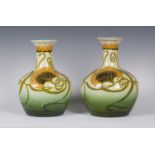 A matched pair of Continental art pottery vases, circa 1900, the bulbous bodies with gently flared