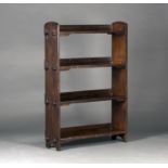 An early 20th century Arts and Crafts stained oak four-tier open bookcase of pegged construction,