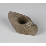 A Danish Neolithic pecked stone axe head of perforated boat form, bearing 'F.S. Clark Collection'