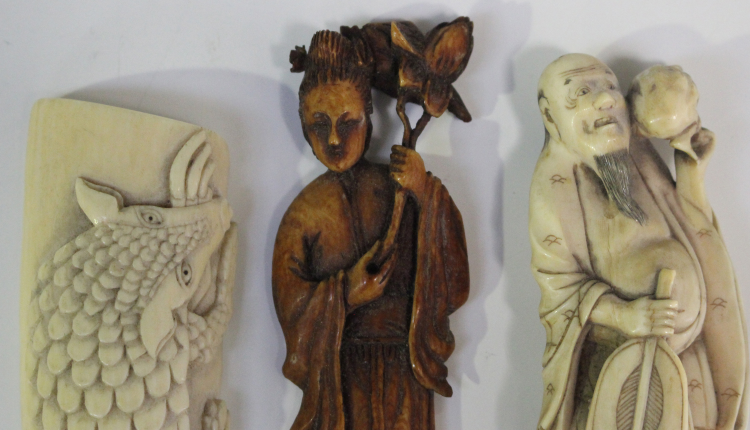 A Chinese brown stained ivory figure of a maiden, late Qing dynasty, modelled standing holding a - Image 4 of 4